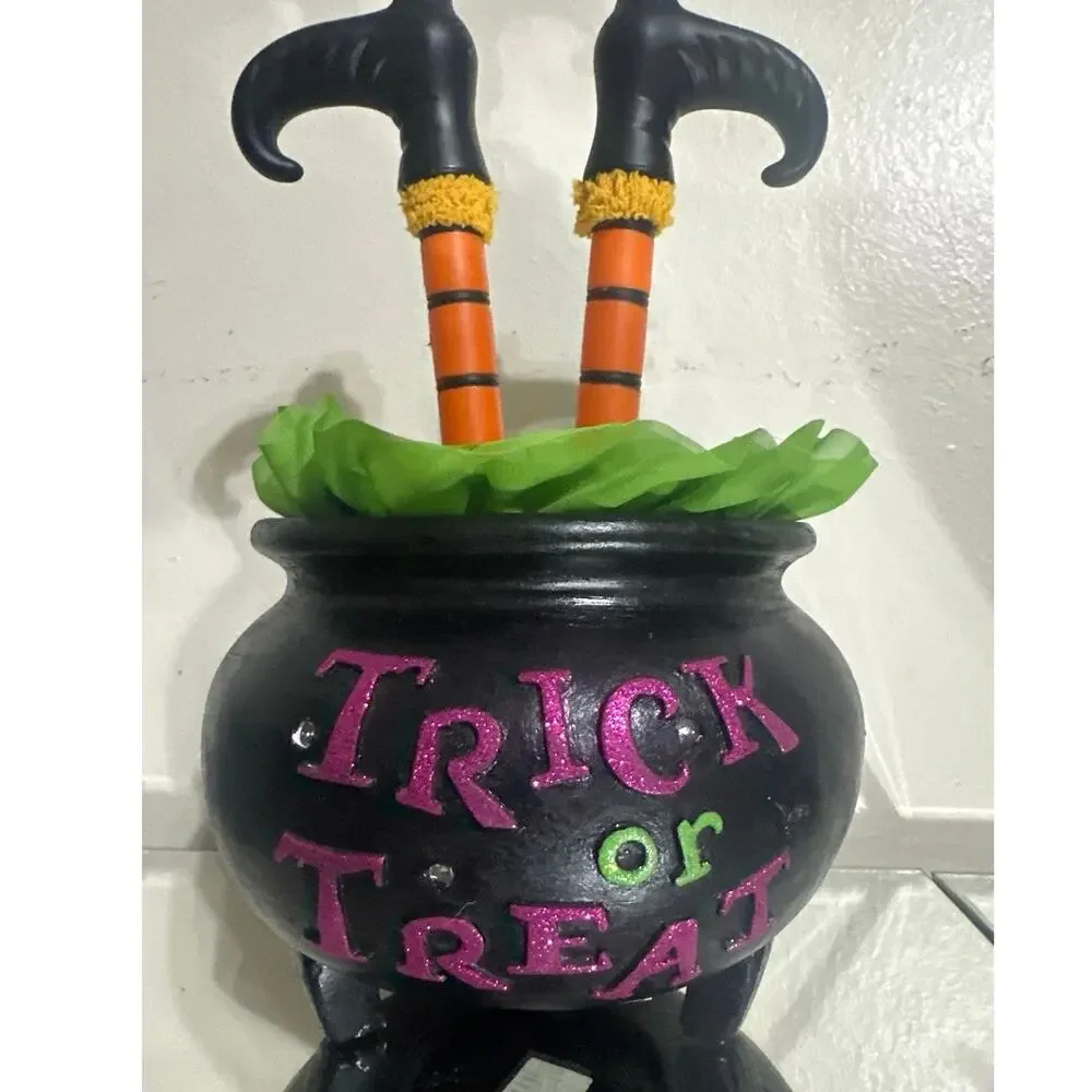 Halloween witch leg cauldron w/black pot labeled 